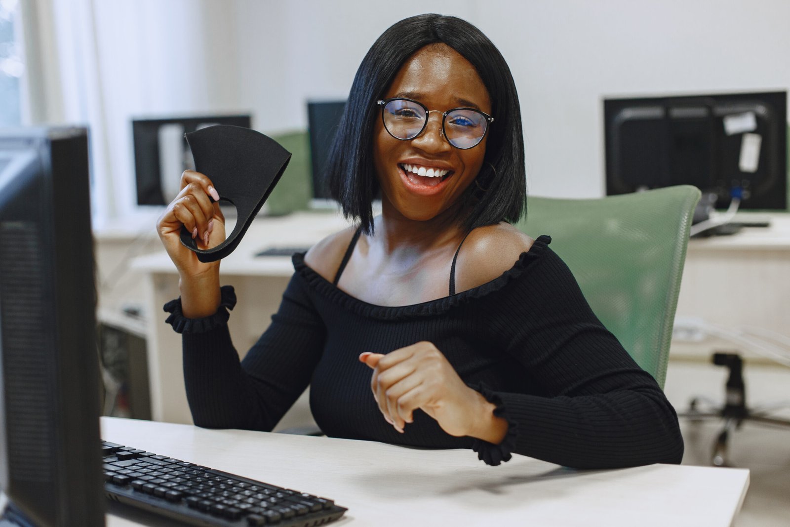 An African girl is sitting at a desk in a computer science class - UncoveringYou - UncoveringYou
